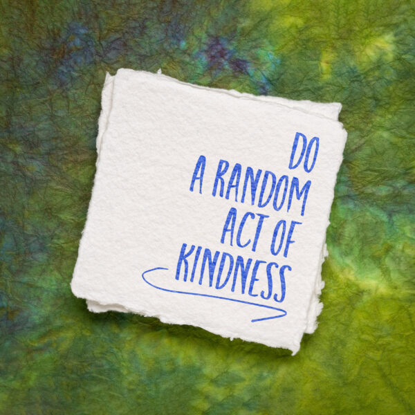 do a random act of kindness inspirational note on an art paper, social concept